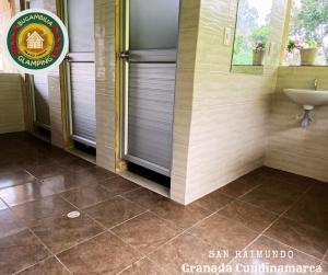 a bathroom with a sink and a mirror at Glamping Bugambilia in Subía