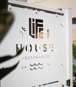 a sign for a hotel with the words life hulse practitioner at Life House B&B in Follonica