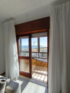 a room with a large window with a view of the beach at CasaMaria in Vila do Conde
