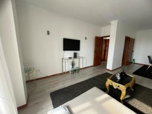 a living room with a couch and a flat screen tv at CasaMaria in Vila do Conde