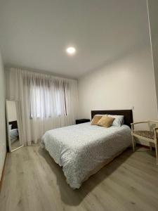 a bedroom with a large bed and a mirror at CasaMaria in Vila do Conde