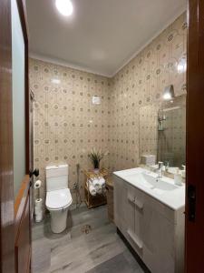a bathroom with a toilet and a sink at CasaMaria in Vila do Conde +40 photos
