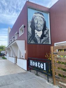a large mural of a man on the side of a building at Hostel Yatel in El Calafate