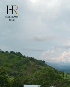 a sign that reads hr harmony risk on a hill at Harmony Risk in Albán