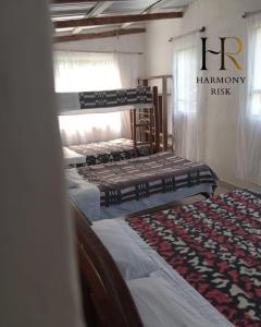 two bunk beds in a room with a harphony risk sign at Harmony Risk in Albán