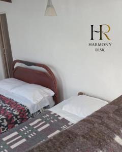 a bedroom with a bed with a blanket on it at Harmony Risk in Albán +2 photos