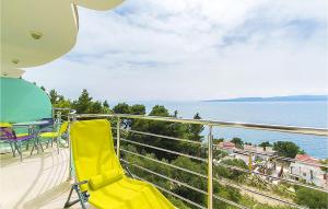 a balcony with a table and chairs and the ocean at Beautiful Apartment In Brela With Wifi in Brela +9 photos