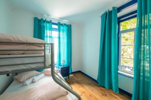a bedroom with a bunk bed and a window at Help Yourself Hostels - Parede in Parede +25 photos