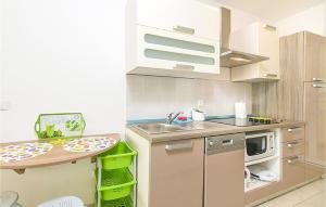 a small kitchen with a sink and a table at Beautiful Apartment In Brela With Wifi in Brela