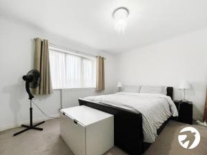 a white bedroom with a bed and a camera at 6 Bed Longstay & Shortstay property with Wifi & parking sleeps 14 in Chatham