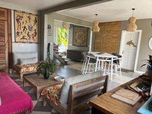 a living room with a couch and a table at Habitation Tara in Capesterre-Belle-Eau