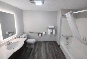 a bathroom with a sink and a toilet and a tub at Days Inn by Wyndham Sturgis SOUTHDAKOTA in Sturgis +22 photos