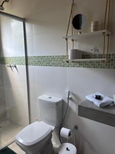 a white bathroom with a toilet and a shower at Casa Reserva da Gávea Visconde de Mauá in Visconde De Maua