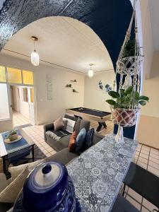 a living room with a couch and a pool table at Casa Valentía in Tequila