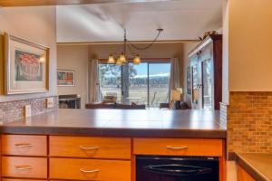 a kitchen with a counter and a dining room at Lodge Condo 021 in Black Butte Ranch +6 photos