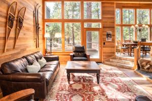 a living room with a leather couch and a table at Rock Ridge 009 in Black Butte Ranch