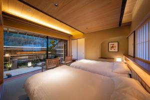 a room with three beds and a large window at Suihoen in Gero +62 photos