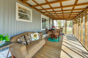 a living room with a couch and a table at Lakefront w/ Dock, Detached Studio, Fire Pit! in Georgetown