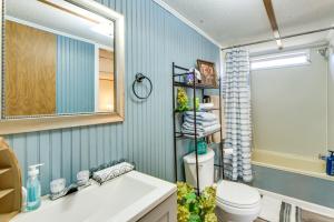 a bathroom with a sink and a mirror and a toilet at Lakefront w/ Dock, Detached Studio, Fire Pit! in Georgetown