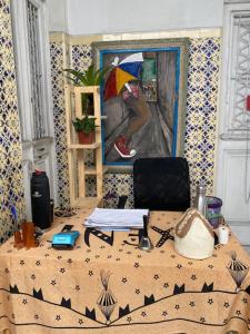 a table with a painting of a person holding an umbrella at Borba Beach House in Recife