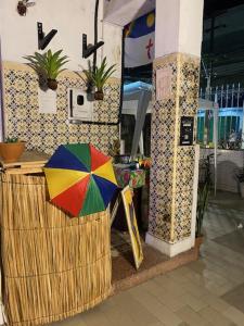 a colorful umbrella sitting outside of a store at Borba Beach House in Recife