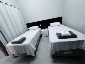 two beds in a hotel room with towels on them at Hotel Luxx in Sinop