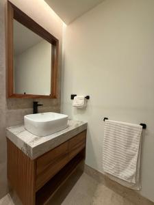 a bathroom with a sink and a mirror at Beach Studio Playa del Carmen MX in Playa del Carmen