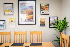 a dining room with a table and some pictures on a wall at Moat View Donaghadee in Donaghadee +23 photos