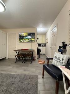 a living room with a table and a kitchen at Suit with Kitchen & Bath in Cocoa +8 photos