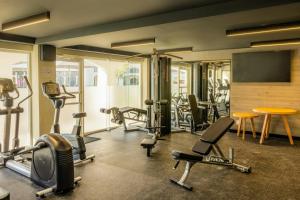 a gym with a bunch of exercise equipment in it at Gamma Ciudad Juarez in Ciudad Juárez
