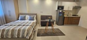 a small bedroom with a bed and a small table at Matina enclaves condo studio type 6thfloor in Davao City