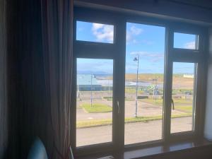 an open window with a view of an airport at Azure Lodge in Bundoran