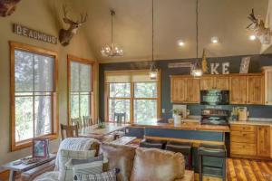 a living room with a couch and a kitchen at The Great Escape in Lead