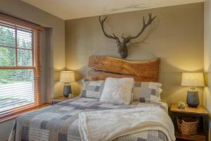 a bedroom with a bed with a deer head on the wall at The Great Escape in Lead