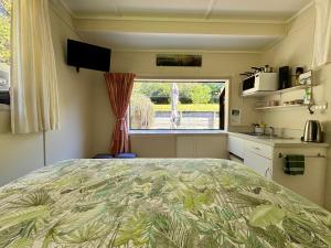 a bedroom with a large bed in a caravan at Ridgehaven Accommodation in Opotiki +34 photos