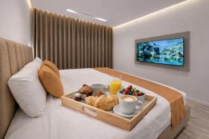 a tray of food on a bed in a hotel room at Sirena Apartment Tangier in Tangier