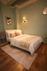 a bedroom with a white bed with a lamp on the wall at Halbinsel am See in Blieskastel