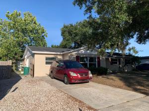 a red car parked in front of a house at Suit with Kitchen & Bath in Cocoa