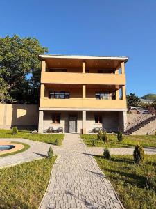 a building with a brick walkway in front of it at VILLAge GOGHT in Goghtʼ