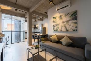 a living room with a couch and a table at Zielo Rentals Palma ,Private balcony, Rooftop Walk to Zocalo in Mexico City +30 photos
