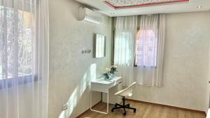 a room with a desk with a chair and a window at A2 Luxe Moderne et Confort, 7 min du Stade Moulay Abdellah in Temara +32 photos