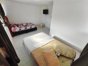 a small room with a bed and a small room with a bed sqor at Hotel y restaurante juanchito in Pitalito +19 photos