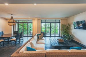 a living room with a couch and a table at Los Altos Resort in Manuel Antonio