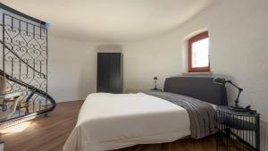 a bedroom with a white bed and a window at Einzigartig übernachten im Wasserturm an der Elbe in Stelle