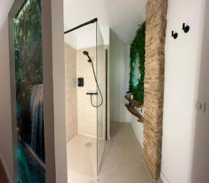a bathroom with a shower with a glass door at Fuera de tiempo in Albalat de la Ribera