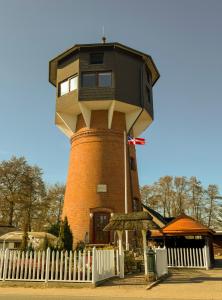 a building with a house on top of it at Einzigartig übernachten im Wasserturm an der Elbe in Stelle