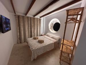 a small bedroom with a bed and a ladder at Fuera de tiempo in Albalat de la Ribera