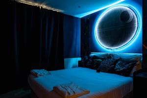 a bedroom with a bed with a moon on it at Disney, Marvel et Star Wars - Proche de Disneyland in Lagny