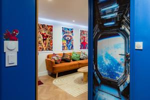 a living room with a couch and a tv at Disney, Marvel et Star Wars - Proche de Disneyland in Lagny +24 photos