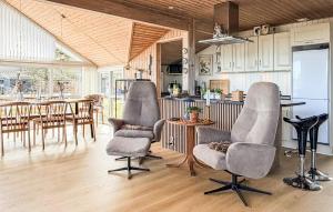 a living room with two chairs and a table at St Croix in Hadsund